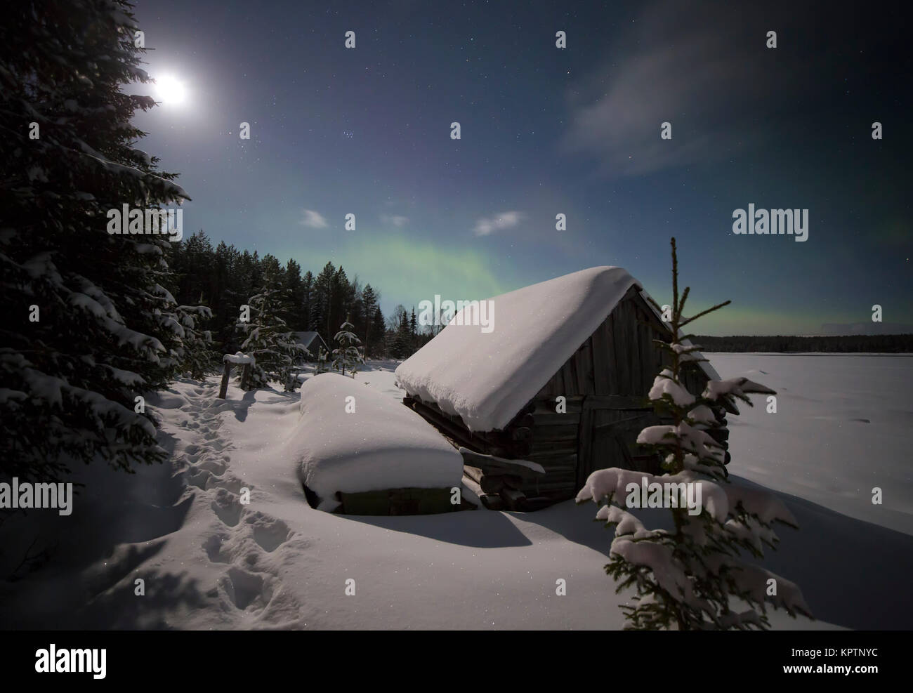 Village house in the lights of moon and Aurora borealis. Northern ...