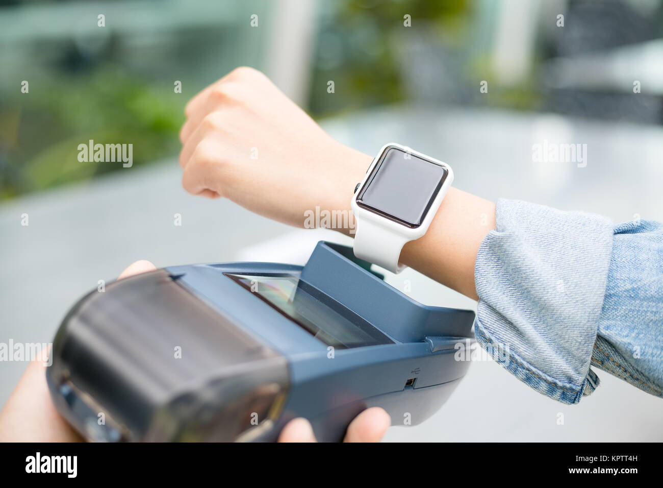 Customer using smart watch to pay Stock Photo Alamy