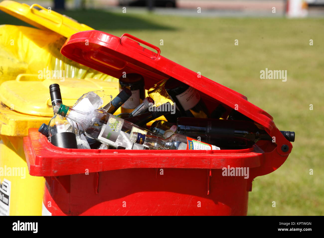 Coloured waste bins, Red bin with empty bottles, glass waste, waste