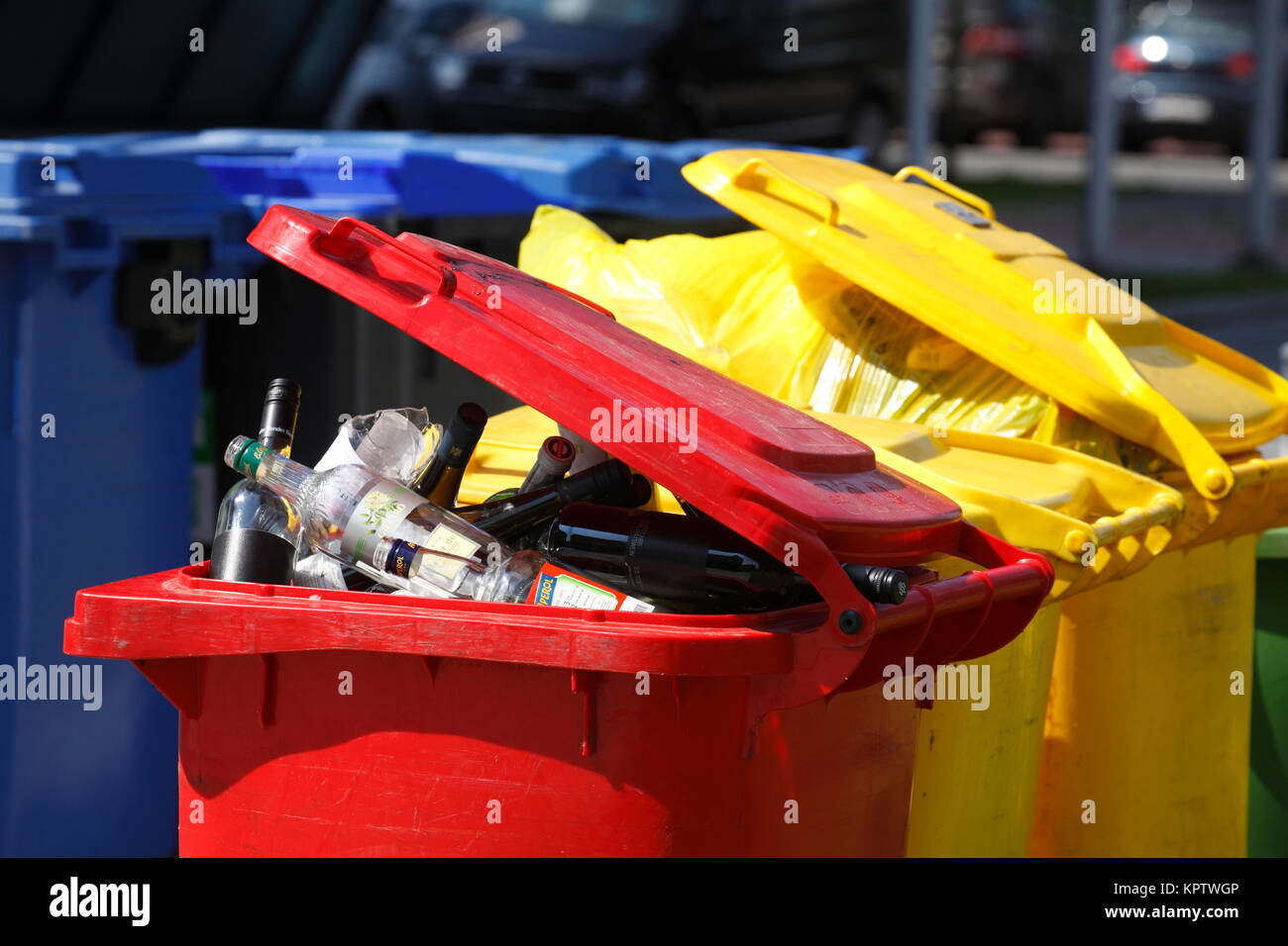 Coloured waste bins, red bin with glass waste, yellow bin with plastic