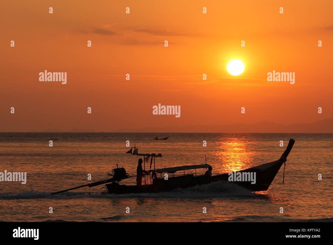 fishing boat at sunset Stock Photo - Alamy