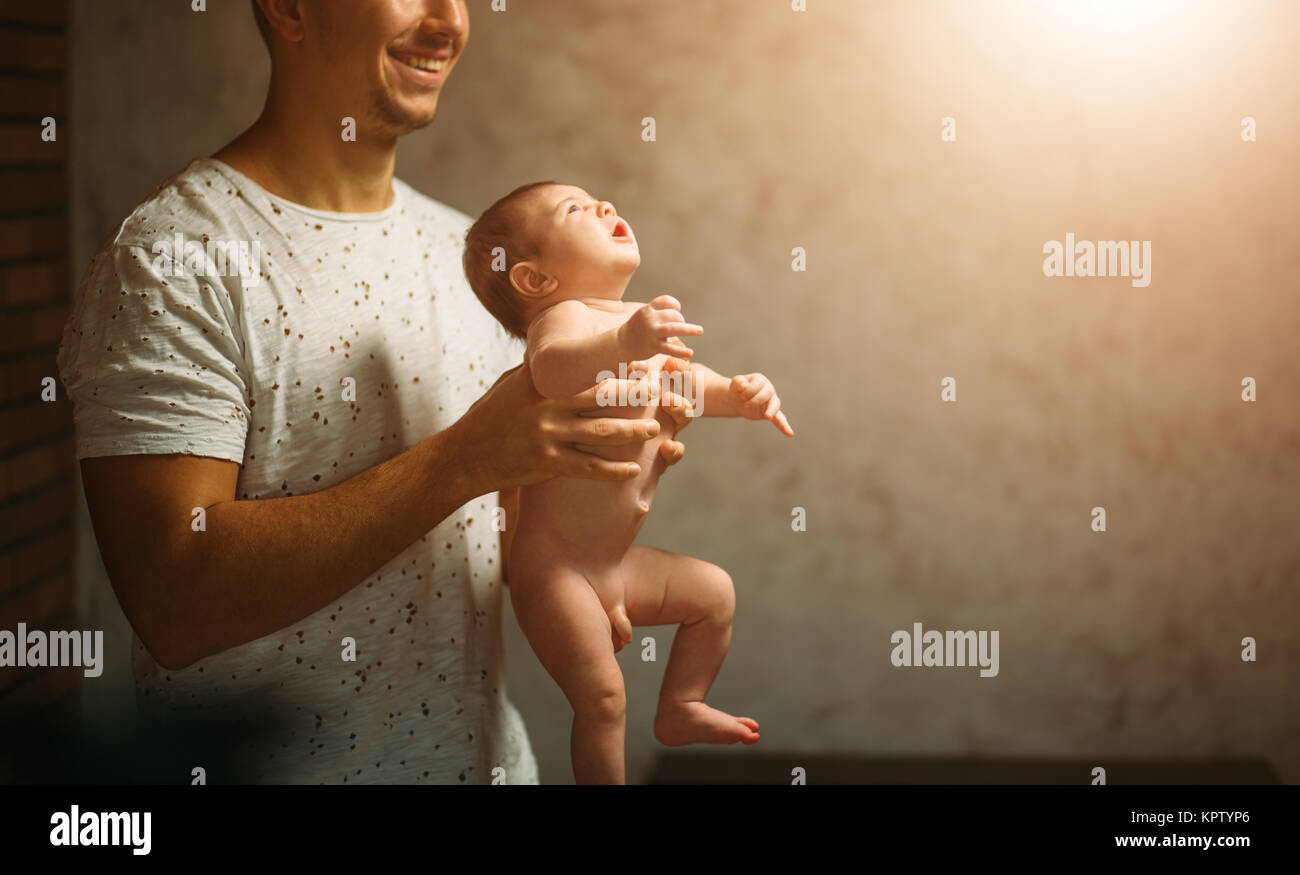 Father lying with cute baby daughter on bed Stock Photo - Alamy