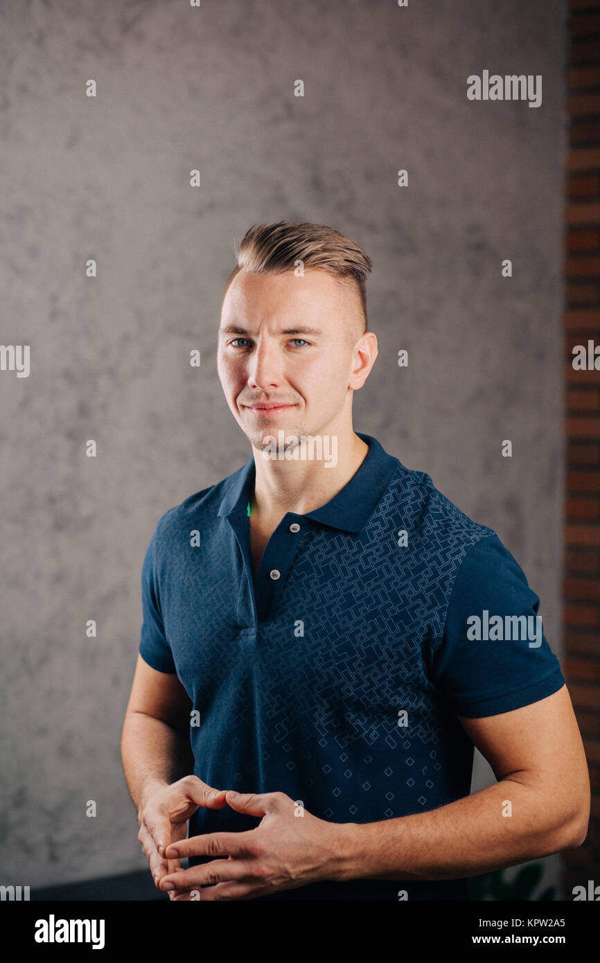 man leaning against a concrete wall and thinking Stock Photo - Alamy