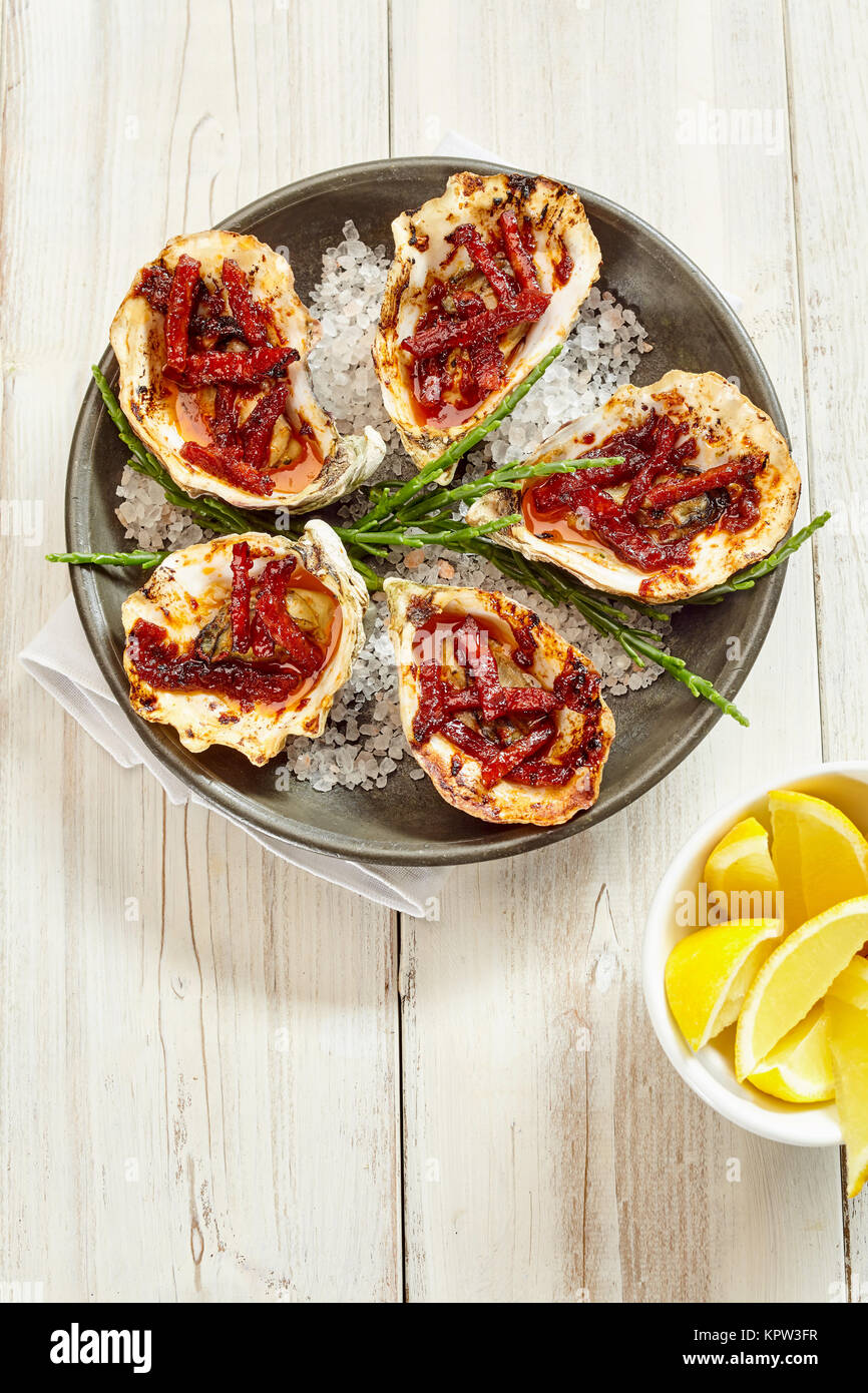 High Angle Still Life View of Plate of Oysters Kilpatrick Prepared with Bacon and Cheese and