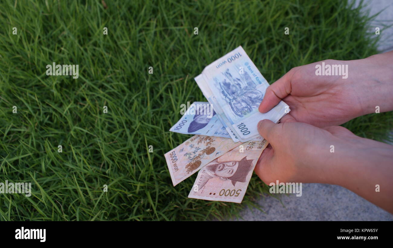 Korean money wons in the hands in park Stock Photo