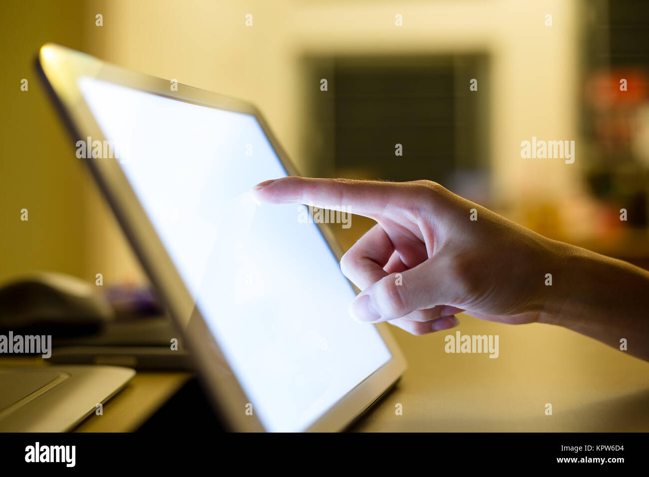Closeup of hand sliding on digital tablet Stock Photo - Alamy