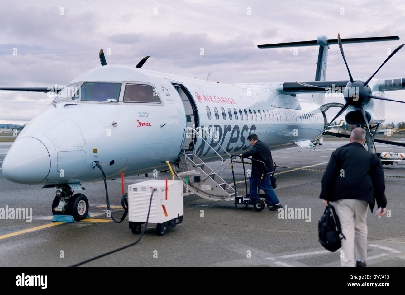 People boarding small Air Canada Jazz Express propeller airplane at Victoria International Airport, British Columbia, Canada 2017 Stock Photo