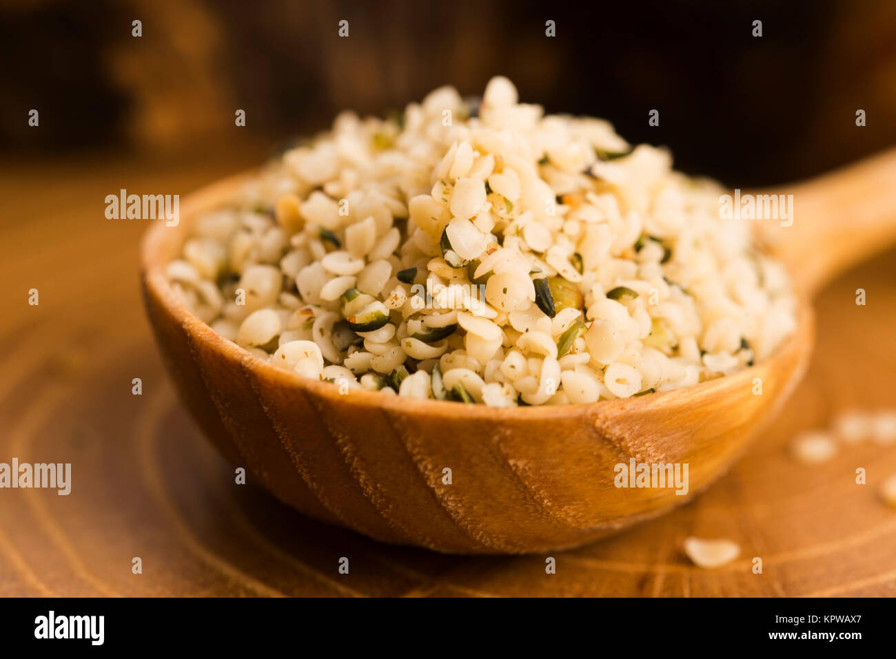 Shelled hemp seeds on wood background Stock Photo - Alamy