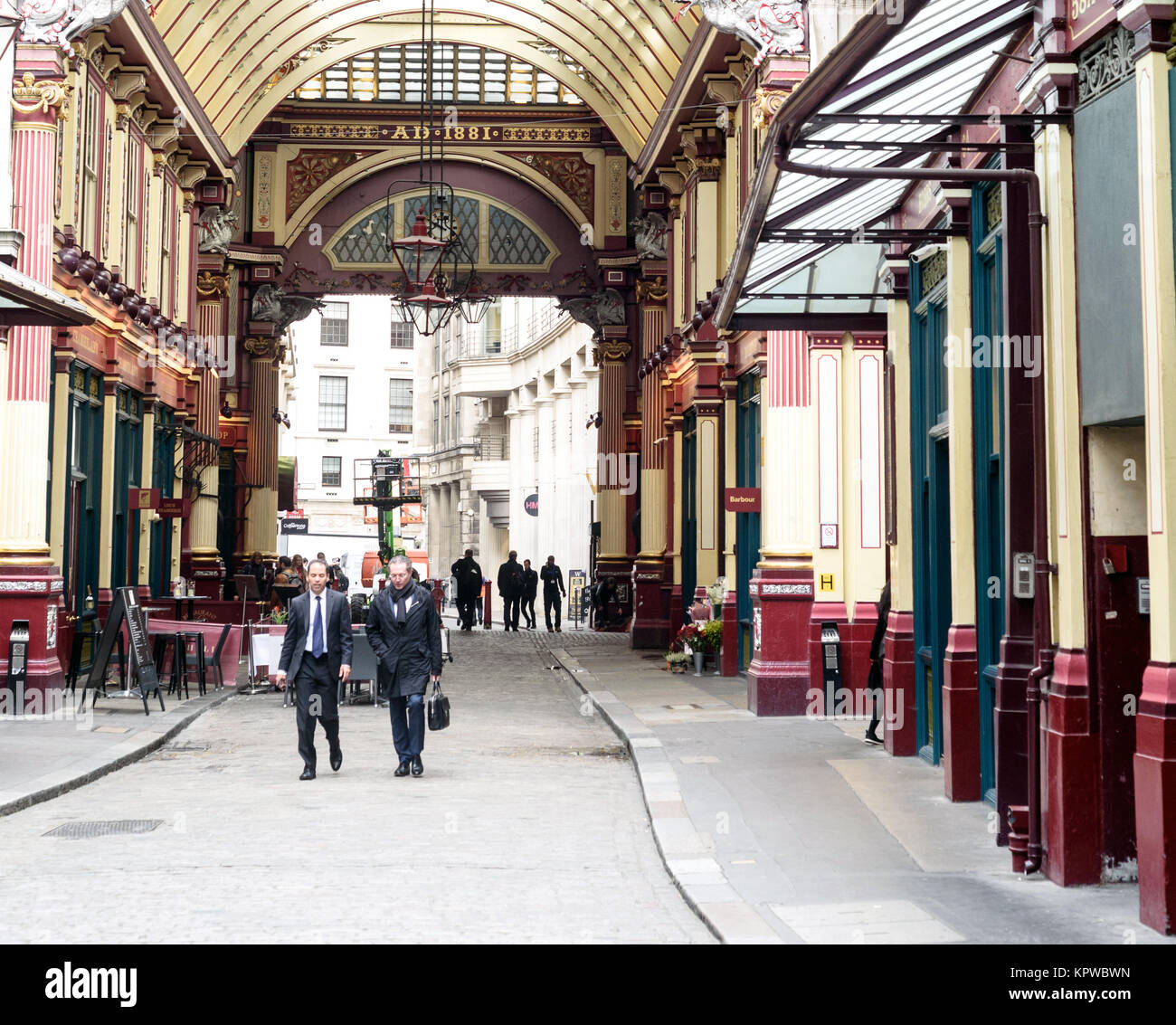 Two business man walk through the interior of the covered Leadenhall Market in London Stock Photo