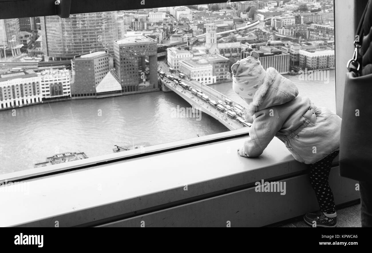 Young child touching glass in the free Sky Garden cafe on the 35th floor of 20 Fenchurch Street in London Stock Photo
