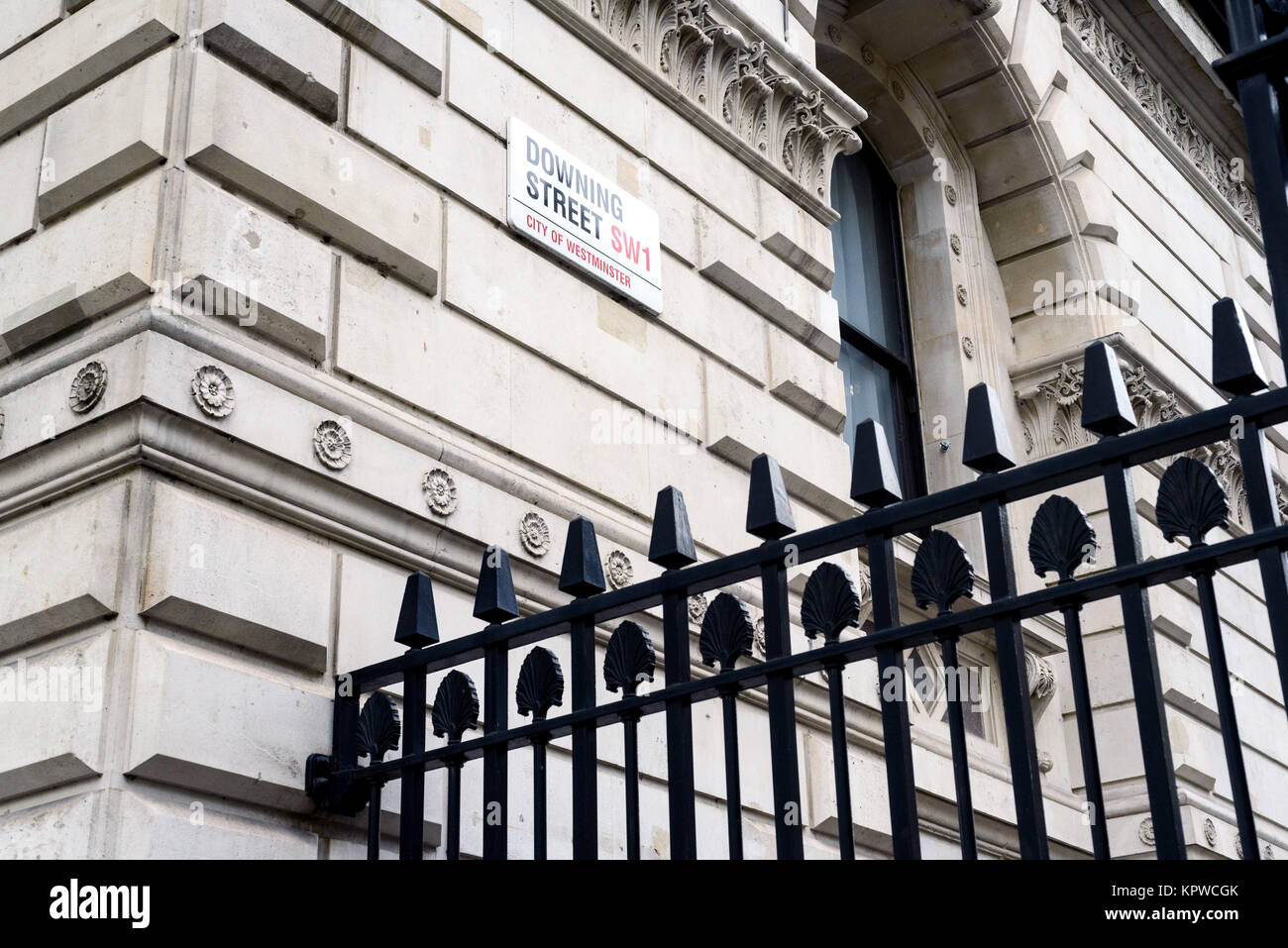 Famous 10 Downing Street SW1 City of Westminster sign on a wall with a black security fence in the foreground with nobody in the image Stock Photo