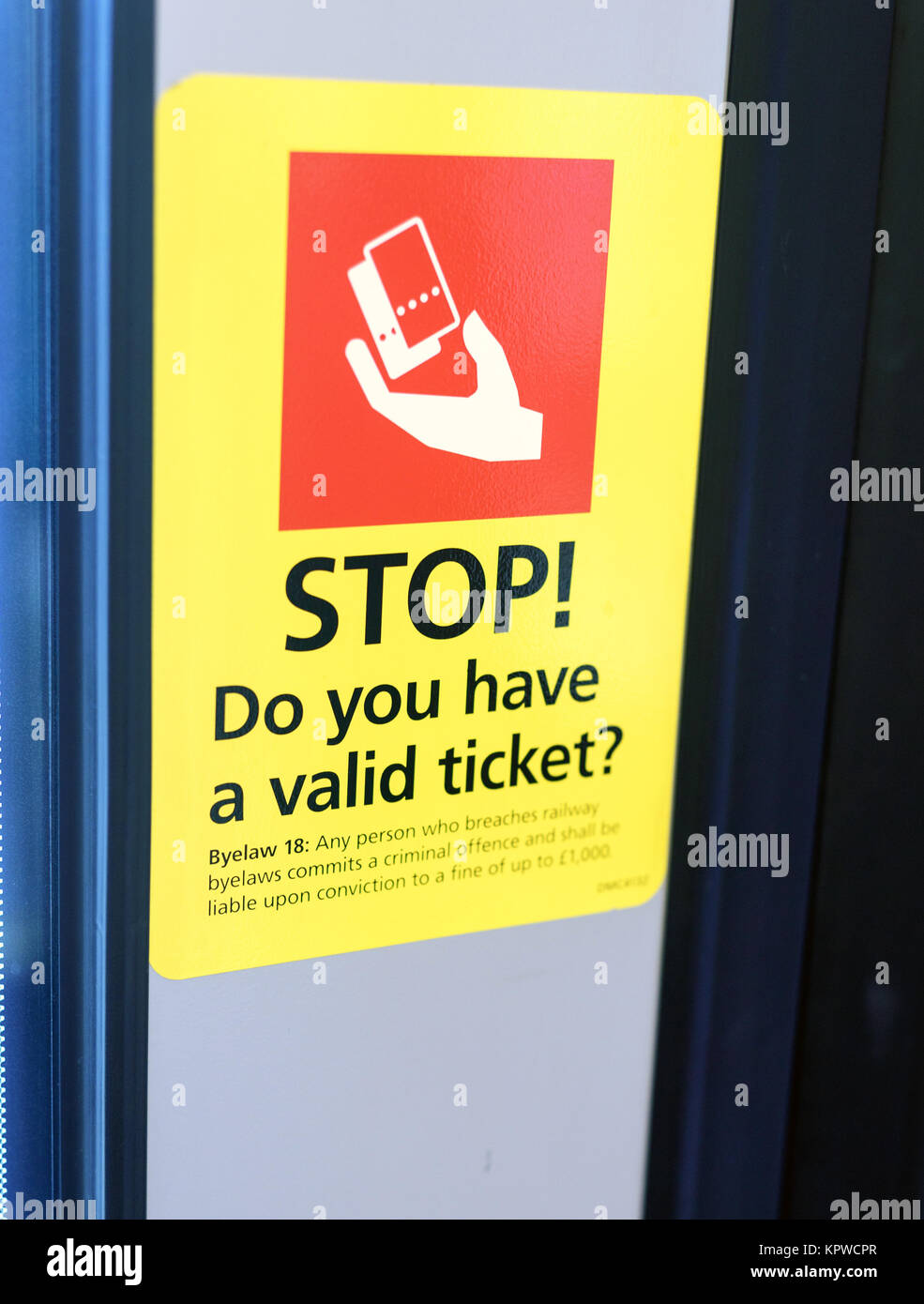 Red and yellow train ticket reminder sign warning about travelling without known as fare evasion Stock Photo