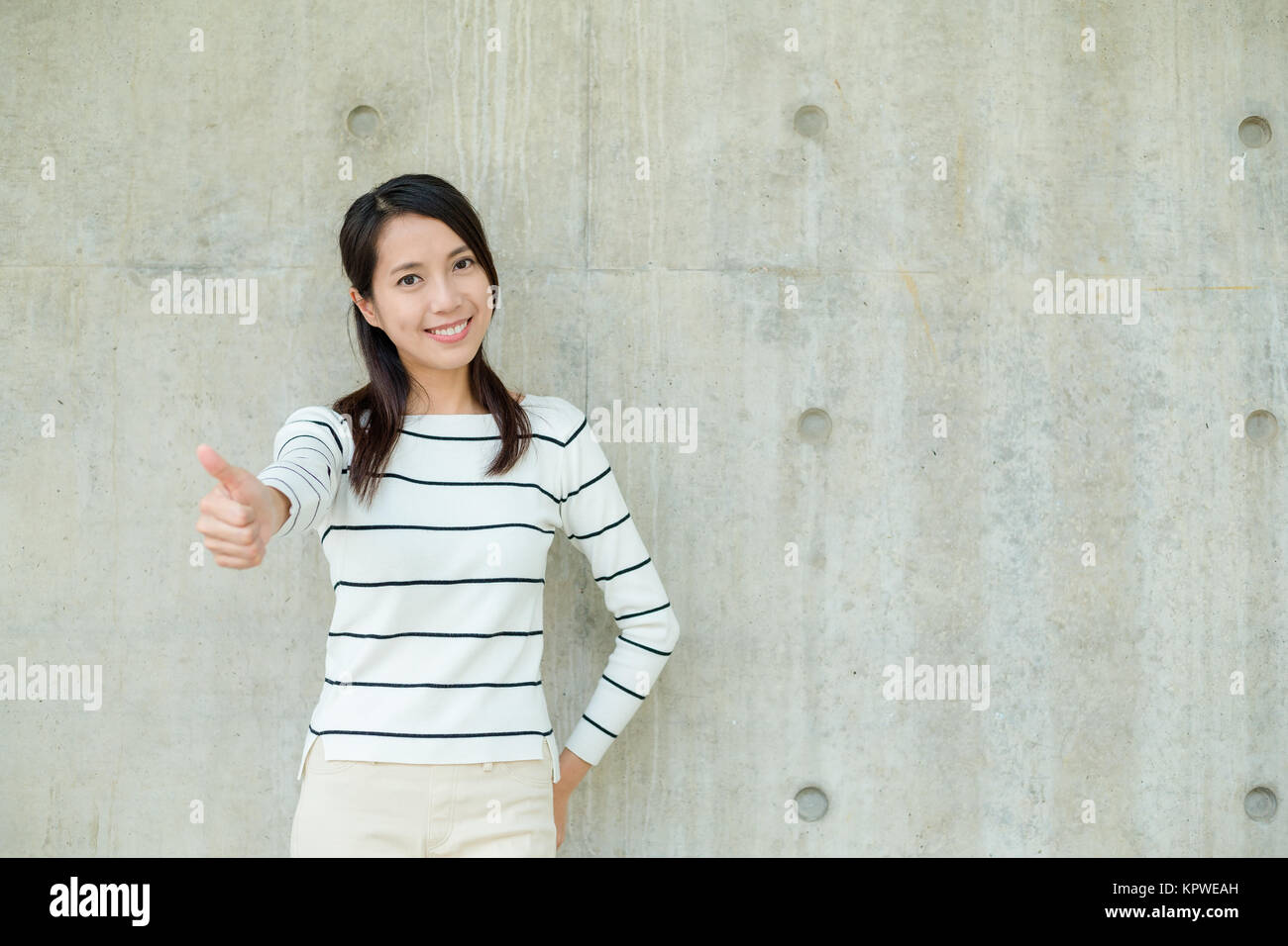 Laughing asian woman showing thumb hi-res stock photography and images ...