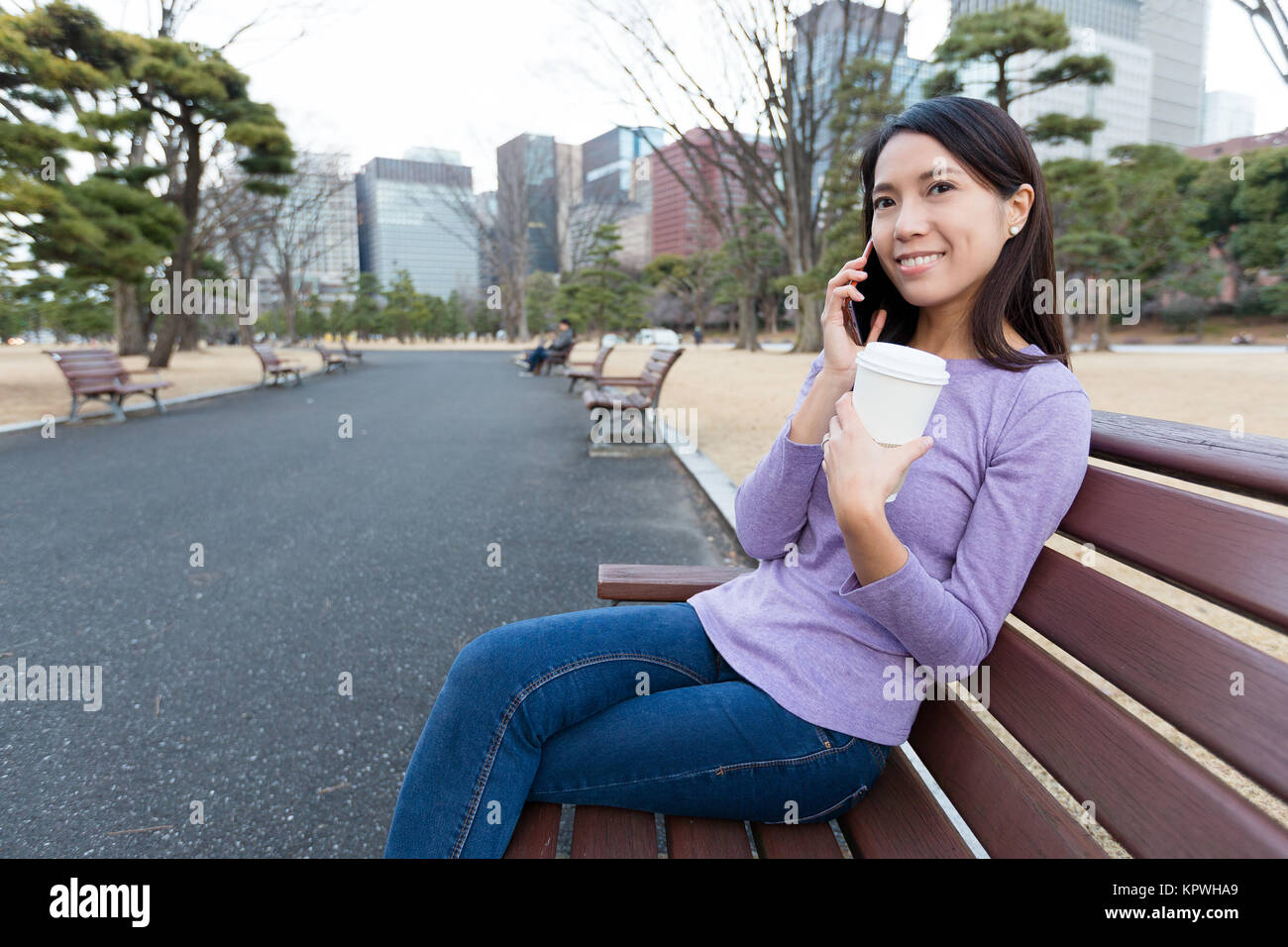 Woman talk to cellphone at park Stock Photo - Alamy