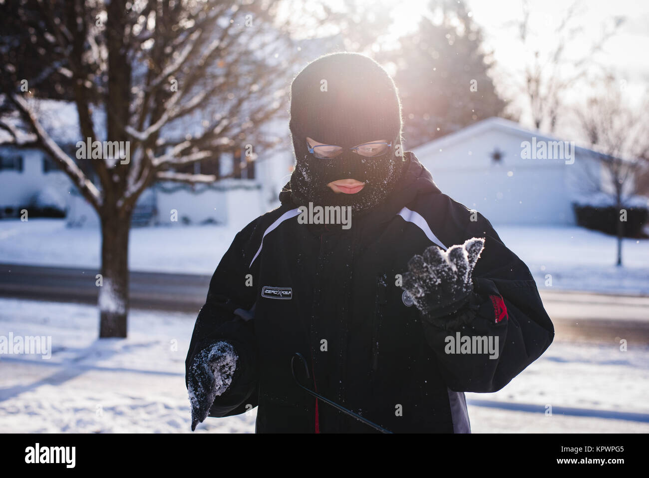 A boy wearing a ski mask stands in the fallen snow in Northern  Pennsylvania, USA Stock Photo - Alamy