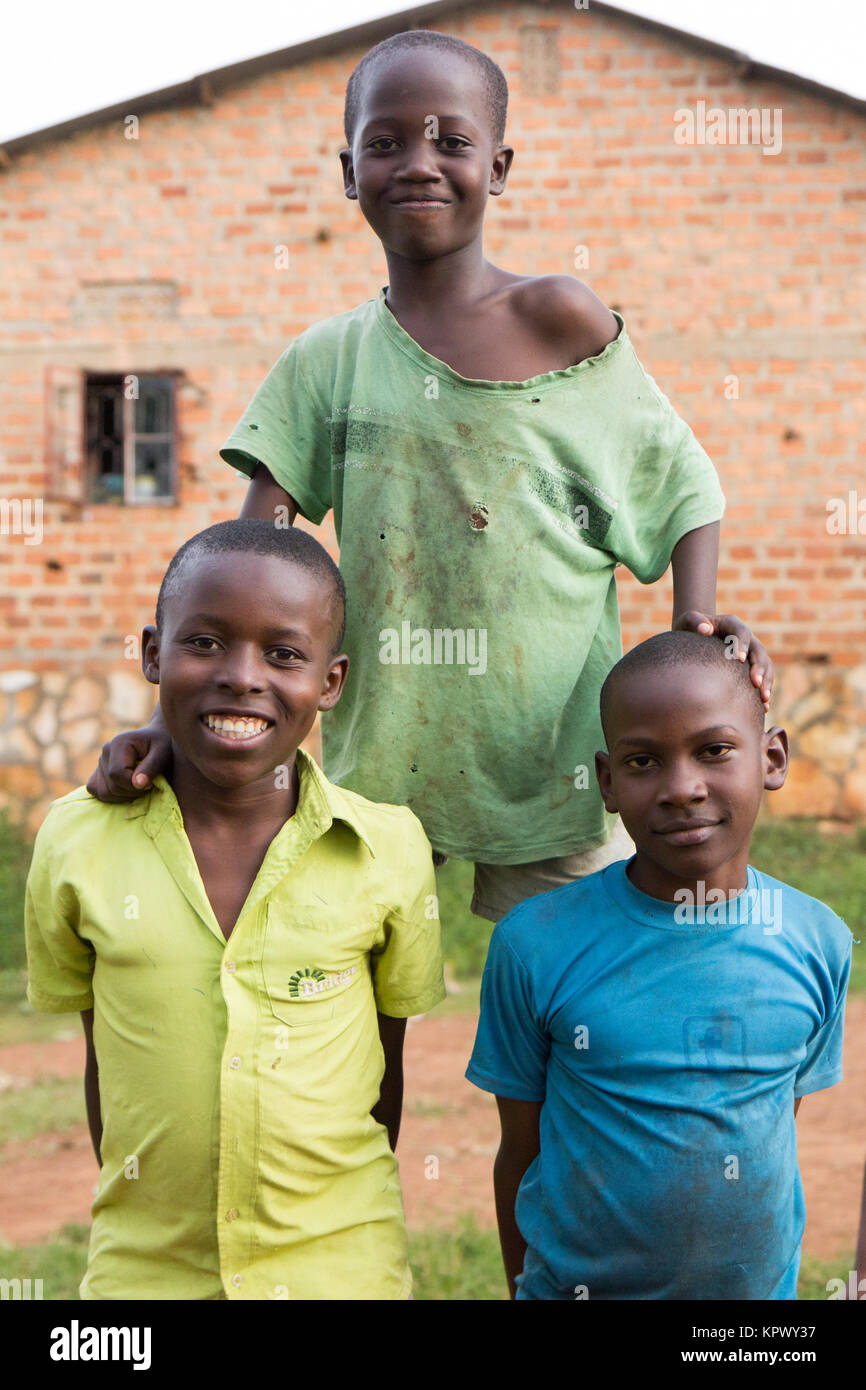 Lugazi, Uganda. 18 June 2017. Three boys making a human pyramid. Stock Photo