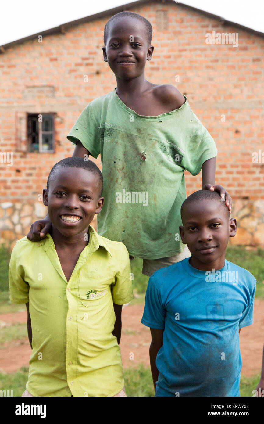 Lugazi, Uganda. 18 June 2017. Three boys making a human pyramid. Stock Photo