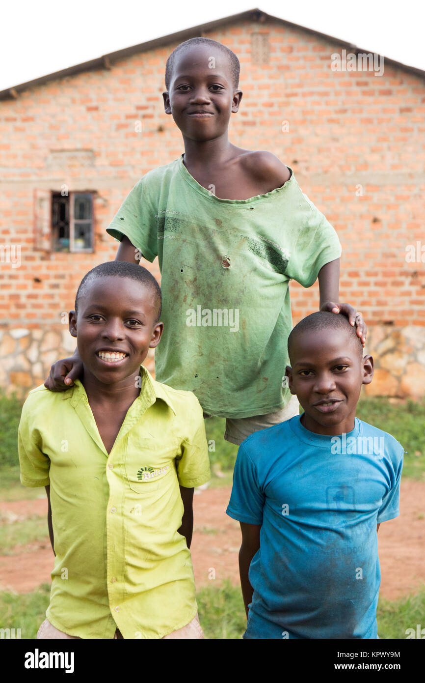 Lugazi, Uganda. 18 June 2017. Three boys making a human pyramid. Stock Photo