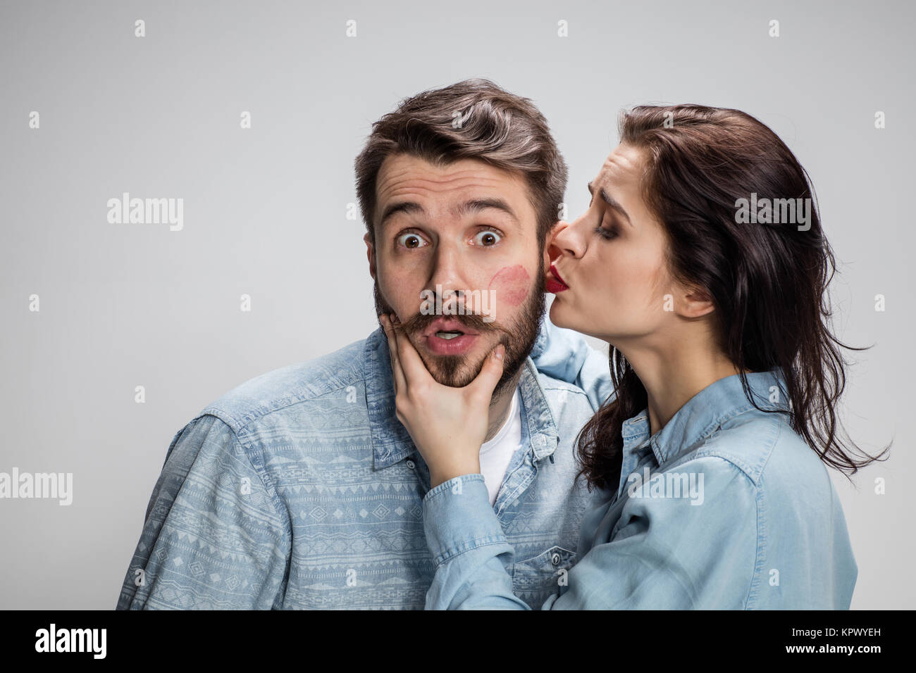 Portrait of happy couple on gray background Stock Photo