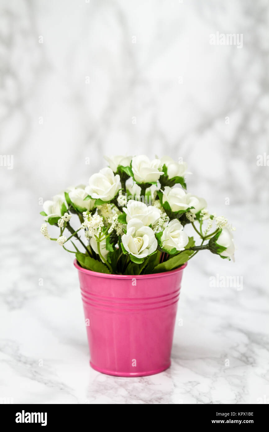Small Decorative Artificial White Flowers in Pink Pot, with copy space