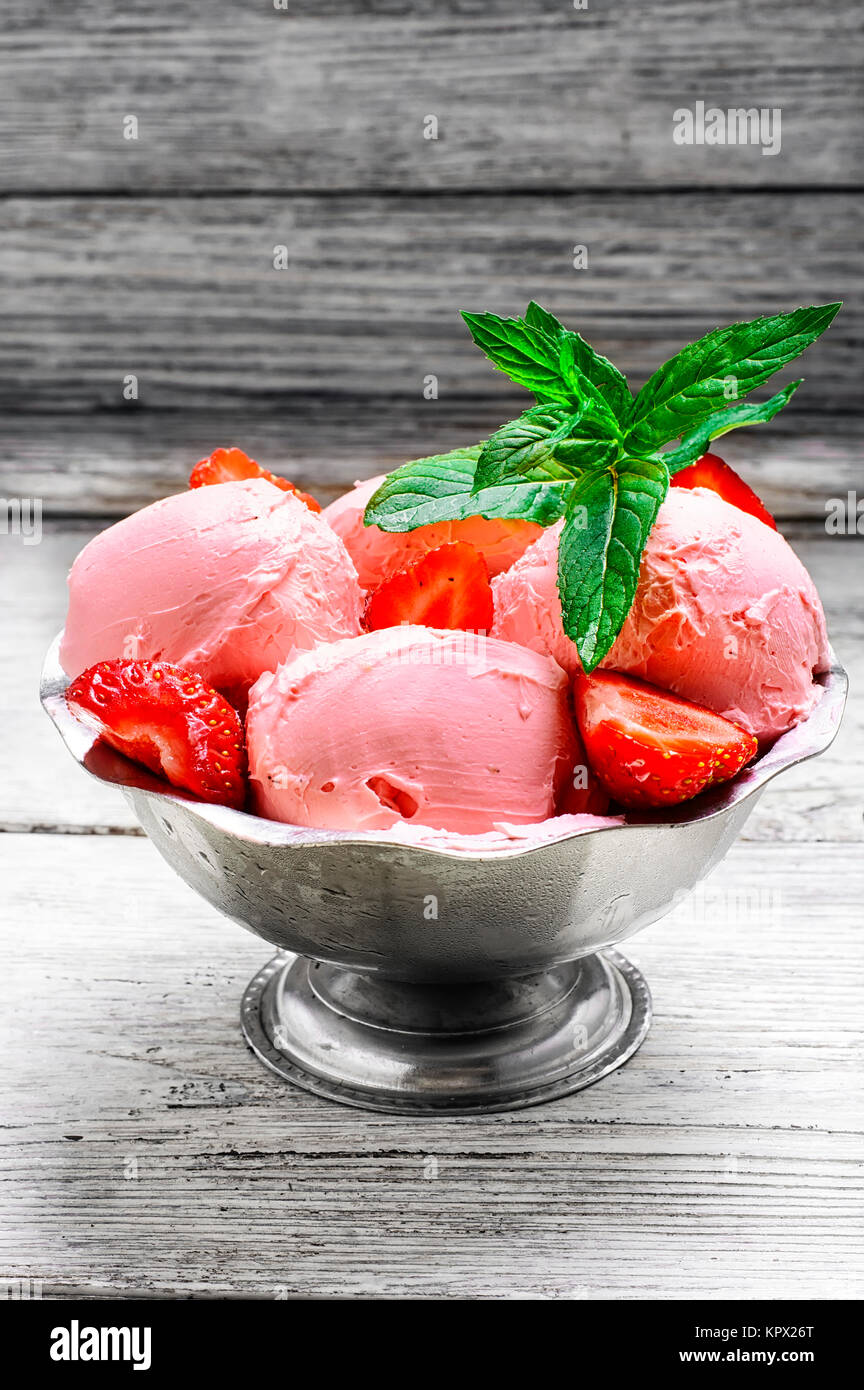 Ice cream with strawberries and leaves of mint in the iron bowl Stock ...