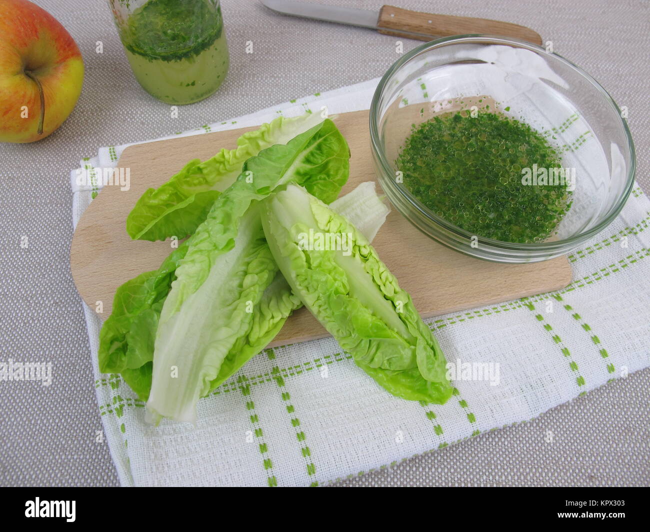 herb vinaigrette salad dressing and salad leaves Stock Photo