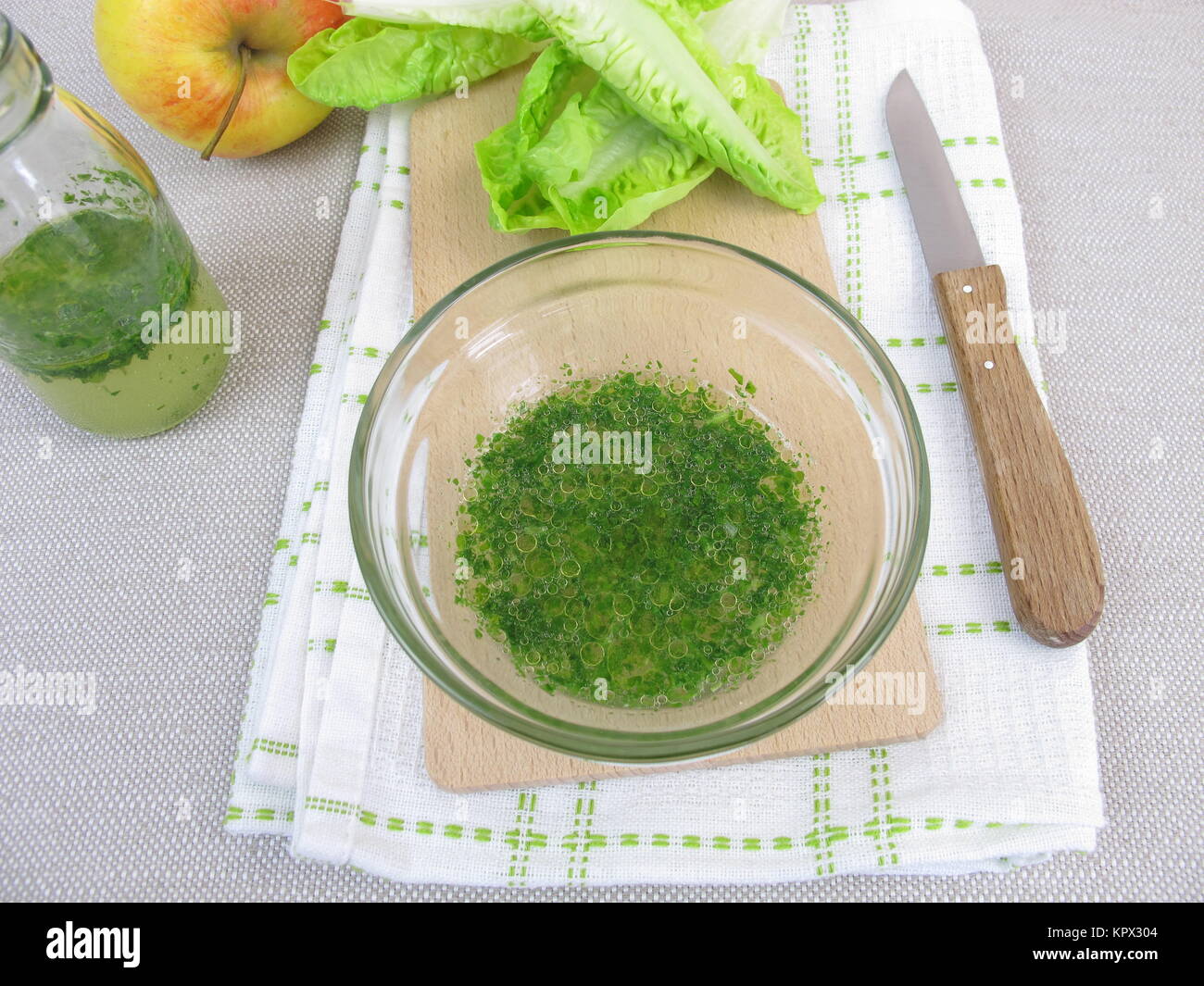 herb vinaigrette salad dressing and salad leaves Stock Photo