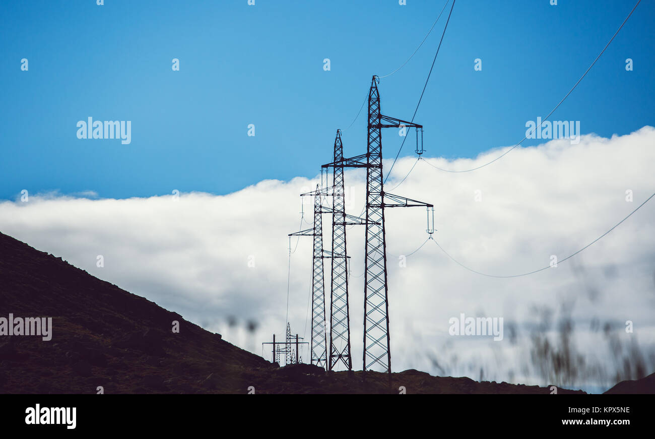 high voltage power lines in mountains nature Stock Photo - Alamy