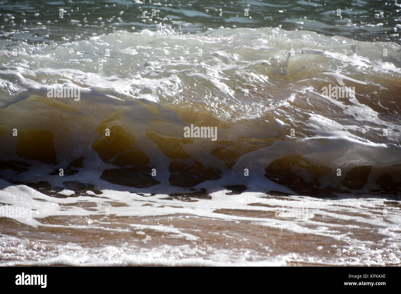 Waves and foam on the beach Stock Photo - Alamy