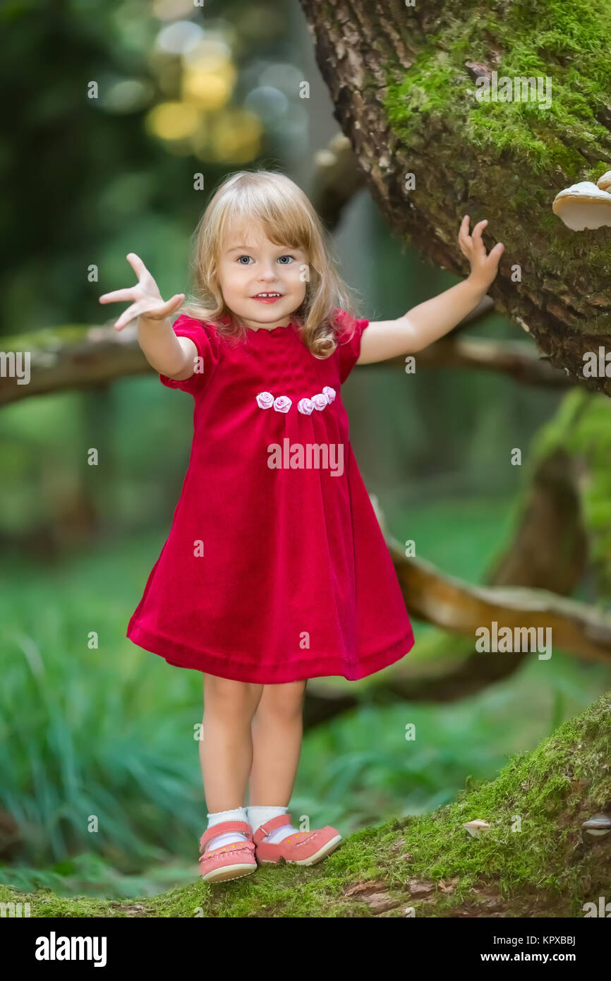 Little girl in the forest Stock Photo - Alamy