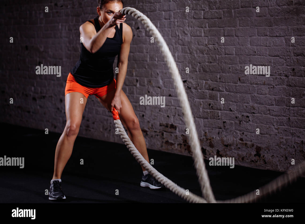 Crossfit Female Ropes Woman training with battle rope in cross fit gym Stock Photo - Alamy