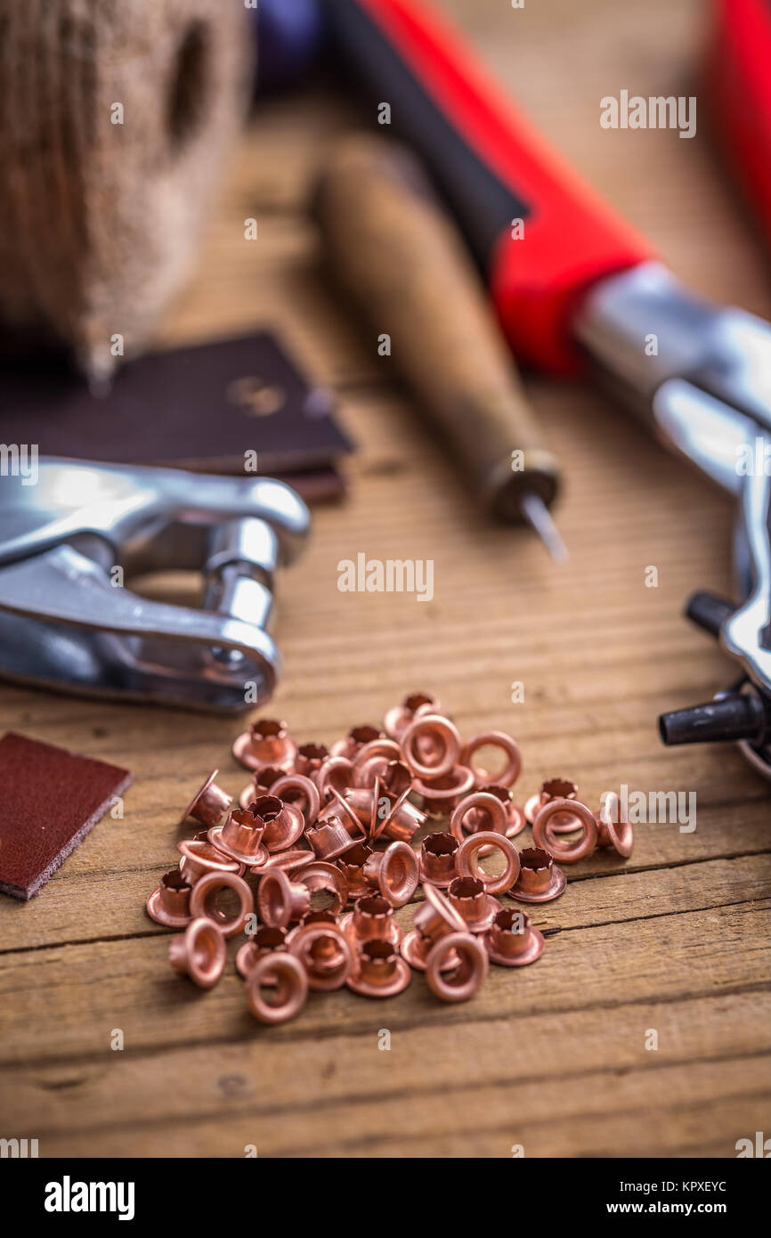 Brass eyelets and eyelet punch Stock Photo Alamy