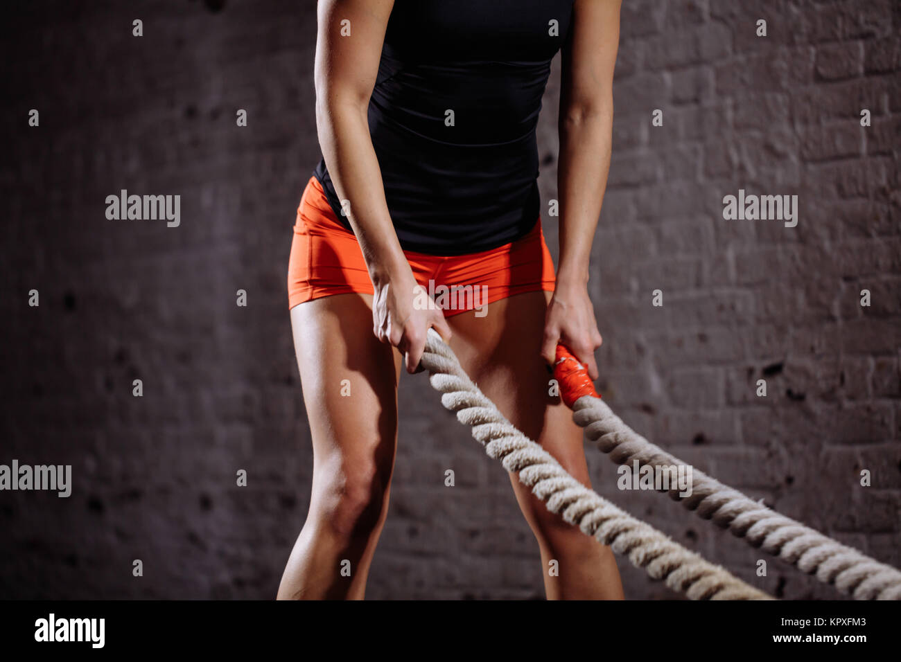 Woman Crossing Rope Woman training battling rope in hi-res stock photography and images - Alamy