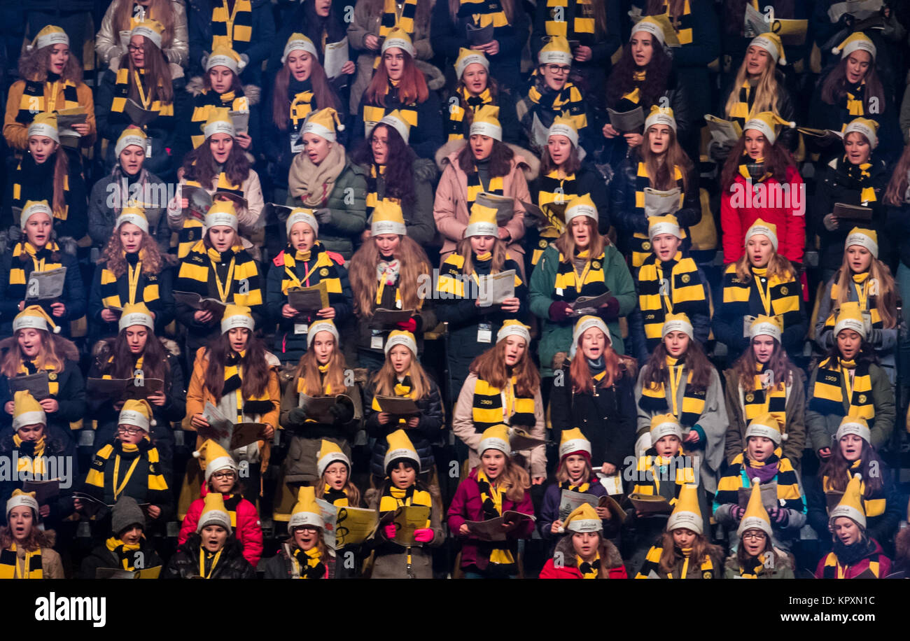 Dortmund, Germany. 17th Dec, 2017. Members of the Dortmund Choral Academy sing Christmas carols at the Signal Iduna Park during the first Christmas Sing-Along Concert with fans of Borussia Dortmund in Germany's largest soccer stadium in Dortmund, Germany, 17 December 2017. Credit: Bernd Thissen/dpa/Alamy Live News Stock Photo