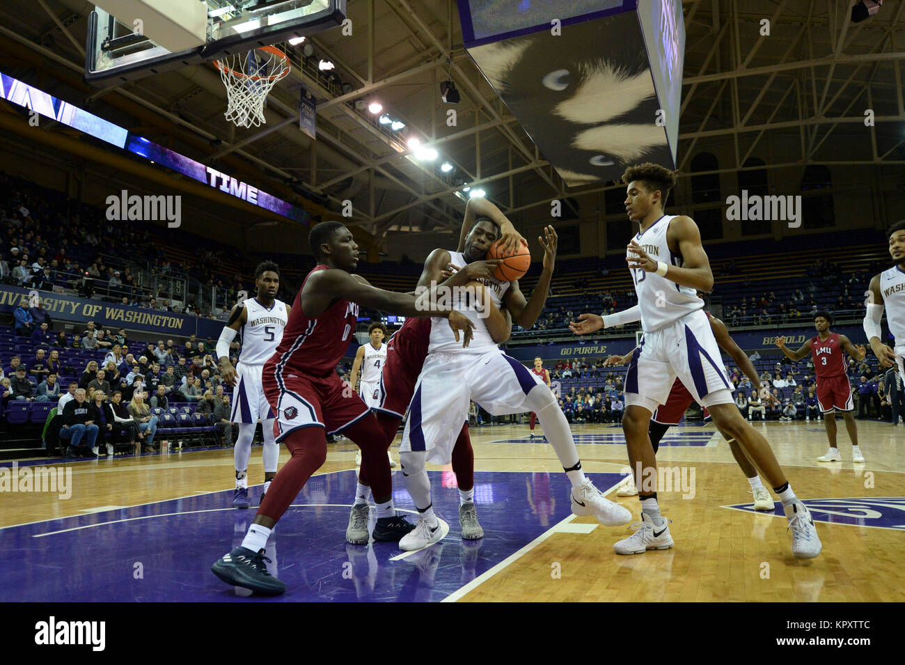 Seattle, WA, USA. 17th Dec, 2017. UW center Noah Dickerson (15) is fouled by LMU's Zafir Williams (1) during an NCAA basketball game between the Washington Huskies and LMU Lions. The game was played at Hec Ed Pavilion in Seattle, WA. Jeff Halstead/CSM/Alamy Live News Stock Photo