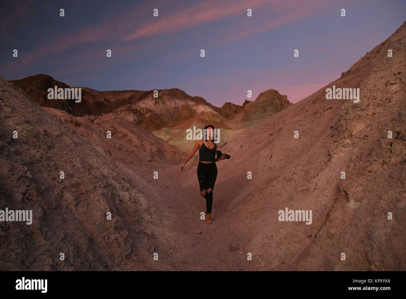 Death Valley National Park, California, USA. 19th Nov, 2017. KATIE GRAVES walking through Artist's Palette as the desert sunset painted the ground pink. Credit: Sarah Murray/Stumbleweeds/ZUMA Wire/Alamy Live News Stock Photo