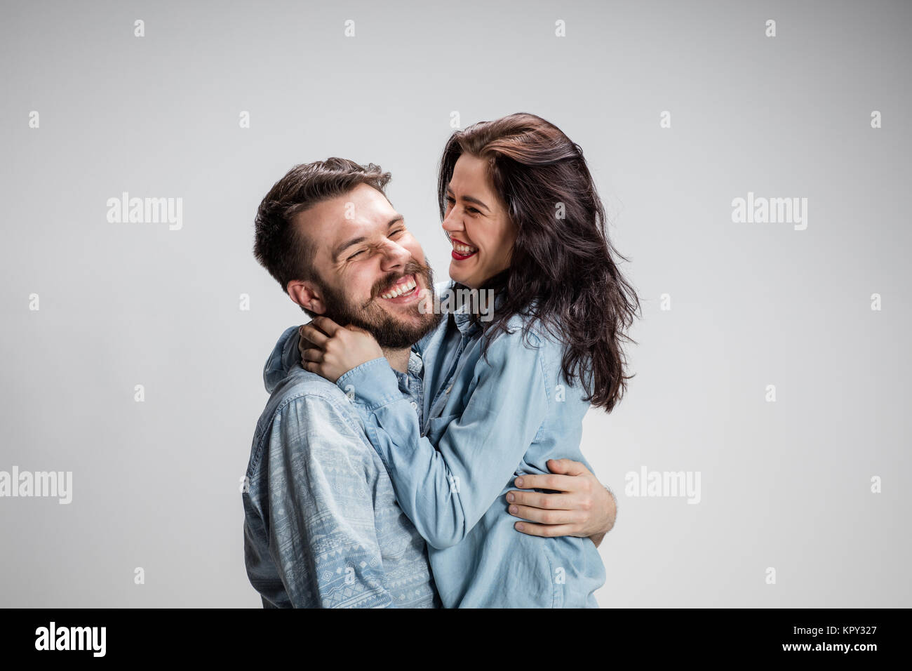 Portrait of happy couple on gray background Stock Photo