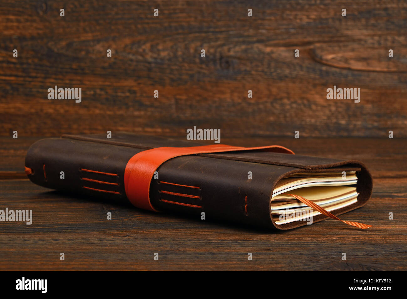 Notebook in leather cover on wooden table Stock Photo - Alamy