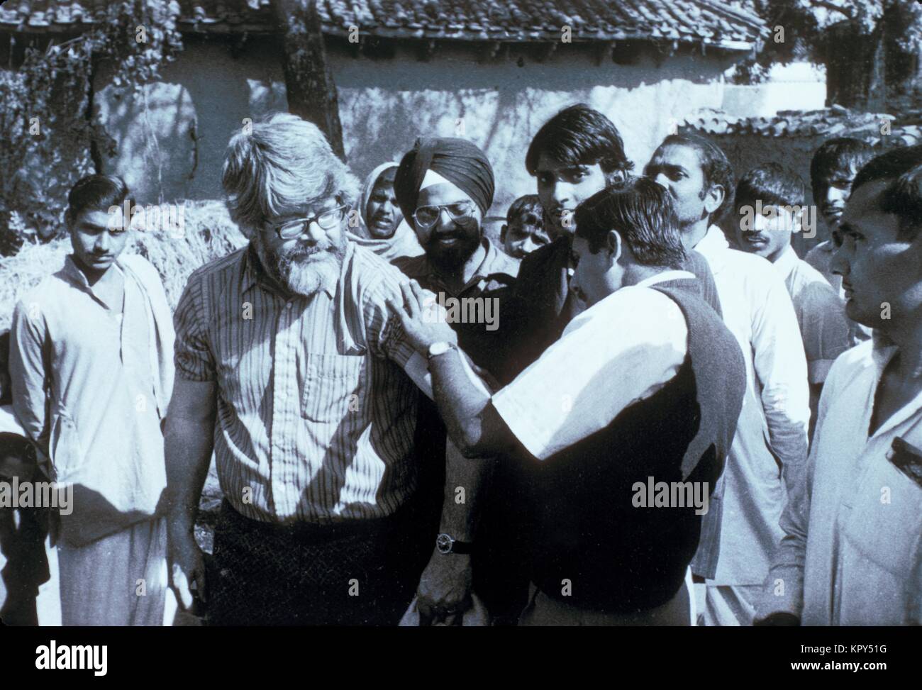 Physician Dr. A. Khan examines the scar from a successful smallpox vaccination on Dr. J. Donald Millar, a WHO Central Assessment Officer from the CDC, is seen, Bhojpur District, Bihar, India, 1975. Image courtesy CDC/Dr. J. D. Millar. Stock Photo