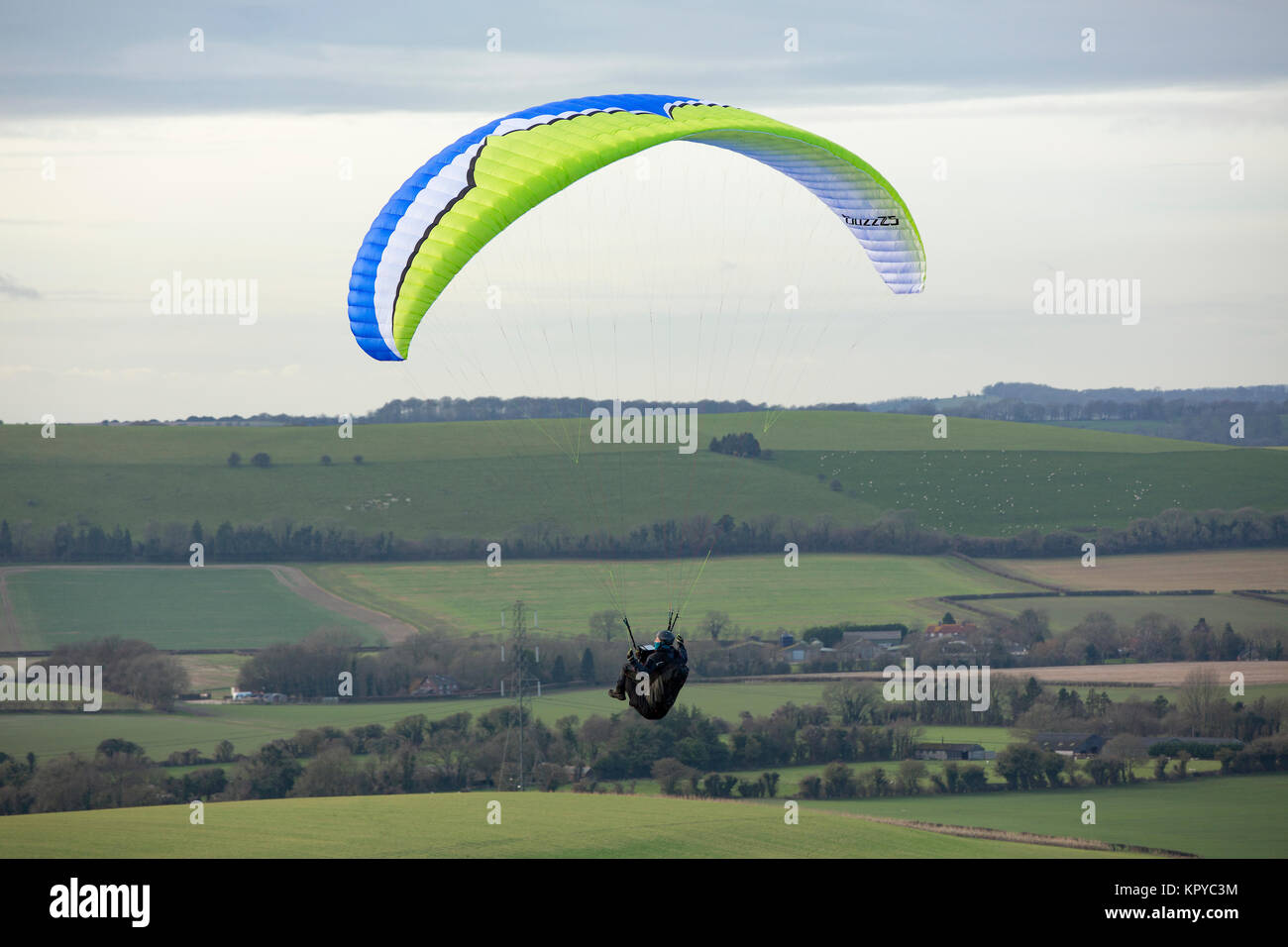 Paragliding on a cold day at Butser Hill near Petersfield Hampshire. Great location where many clubs meet to take advantage of the perfect conditions. Stock Photo