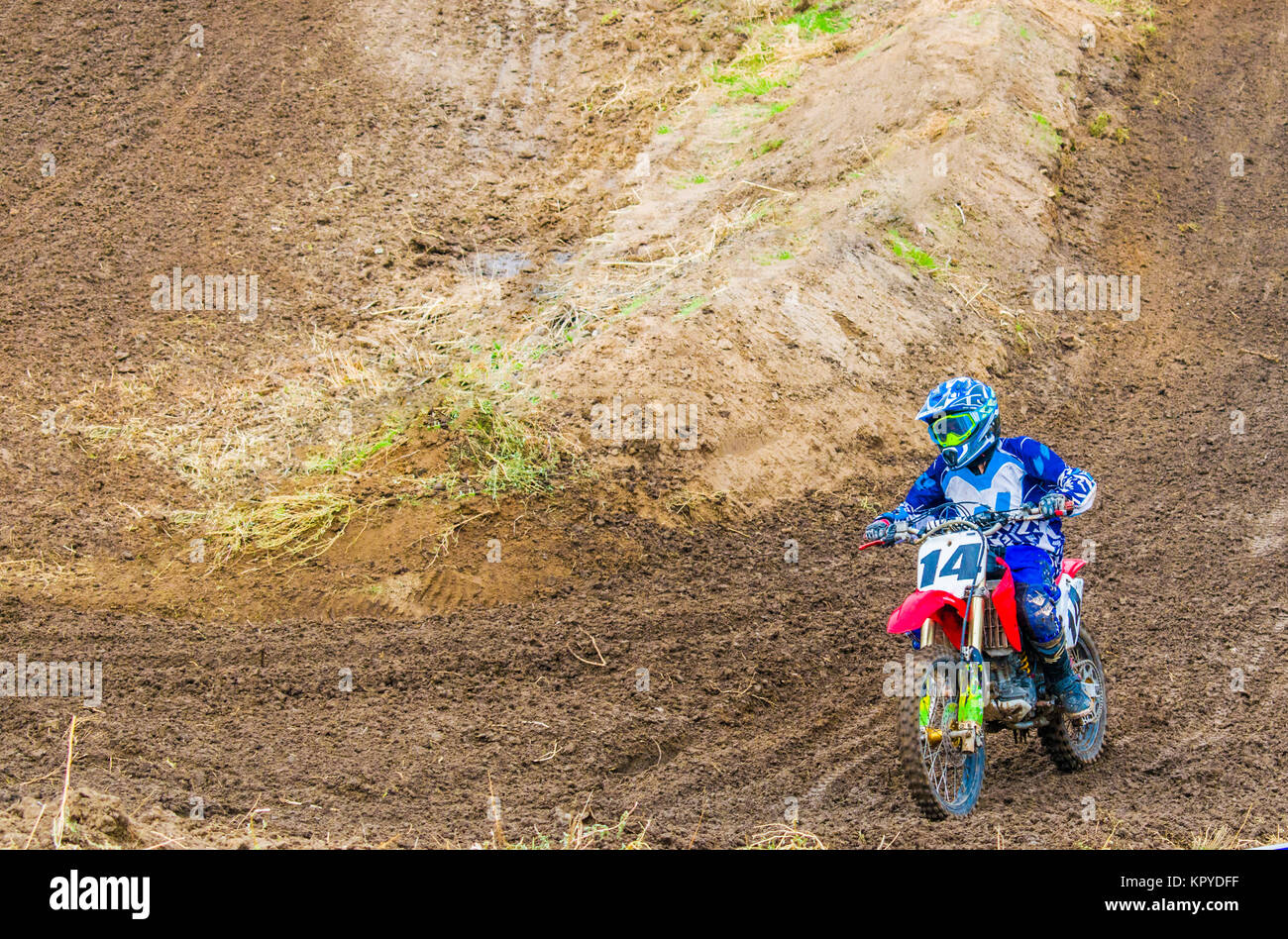 Extreme sport. A rider on a motorcycle rides the sand. Racer on motocicle in blue clothes Stock Photo