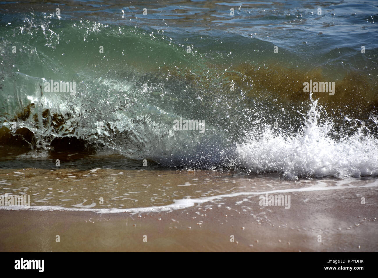Waves and foam on the beach Stock Photo - Alamy