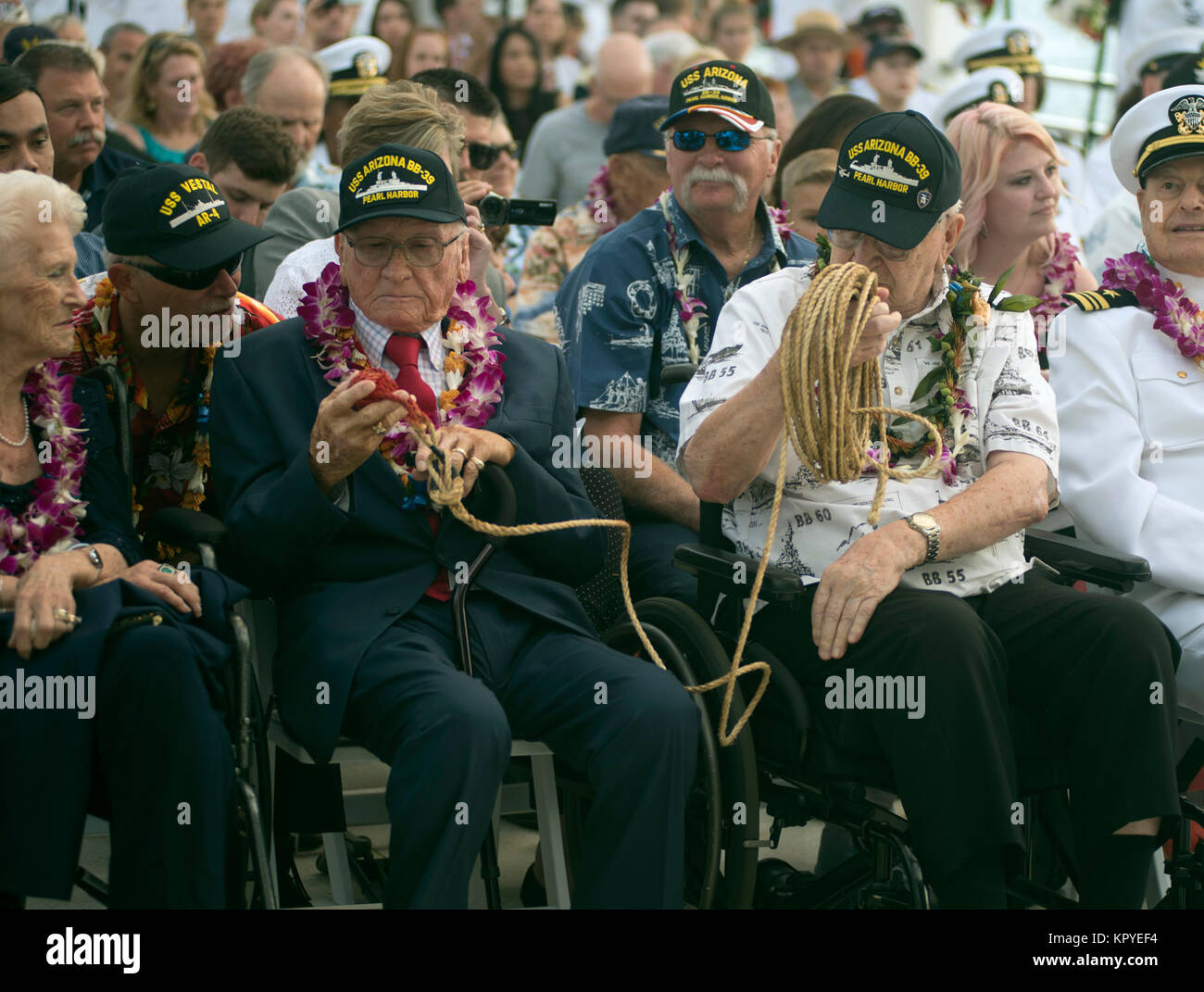 PEARL HARBOR (Dec. 7, 2017) Pearl Harbor survivors Donald Stratton, left, and Lauren Bruner inspect the mooring line used by Chief Boatswain's Mate Joseph L. George during the attacks on Pearl Harbor. George had used the mooring line to rescue Stratton and Bruner from the sinking USS Arizona. George was posthumously honored with the Bronze Star award during the 76th Anniversary events of the attacks on Pearl Harbor and Oahu at Joint Base Pearl Harbor-Hickam. The 76th commemoration, co-hosted by the U.S. Military, the National Park Service and the State of Hawaii, provided veterans, family memb Stock Photo