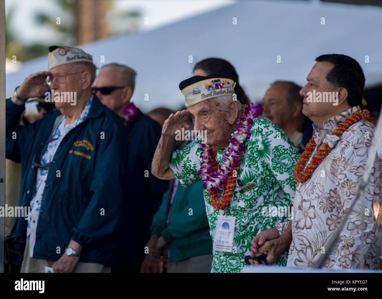 PEARL HARBOR (Dec. 7, 2017) Chief Storekeeper (ret.) Al Rodrigues renders honors during the presentation of colors at the 76th Anniversary of the attacks on Pearl Harbor and Oahu at Joint Base Pearl Harbor-Hickam. The 76th commemoration, co-hosted by the U.S. Military, the National Park Service and the State of Hawaii, provided veterans, family members, service members and the community a chance to honor the sacrifices made by those who were present Dec. 7, 1941, as well as throughout the Pacific theater. Since the attacks, the U.S. and Japan have endured more than 70 years of continued peace, Stock Photo