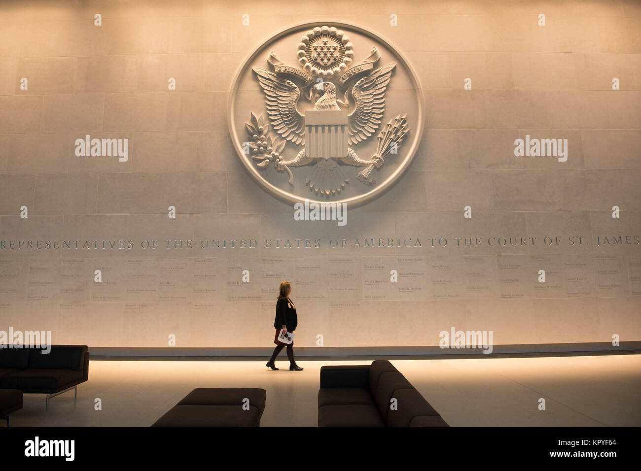 Review of the Year 2017: December: A woman walks beneath a giant cast of the Great Seal of the United States, (used to authenticate certain documents issued by the US federal government), inside the new US Embassy in south London before it opens for business in January 2018. Stock Photo