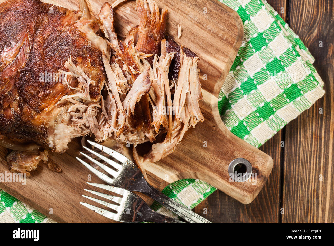 Slow cooked pulled pork shoulder on chopping board. Top view Stock