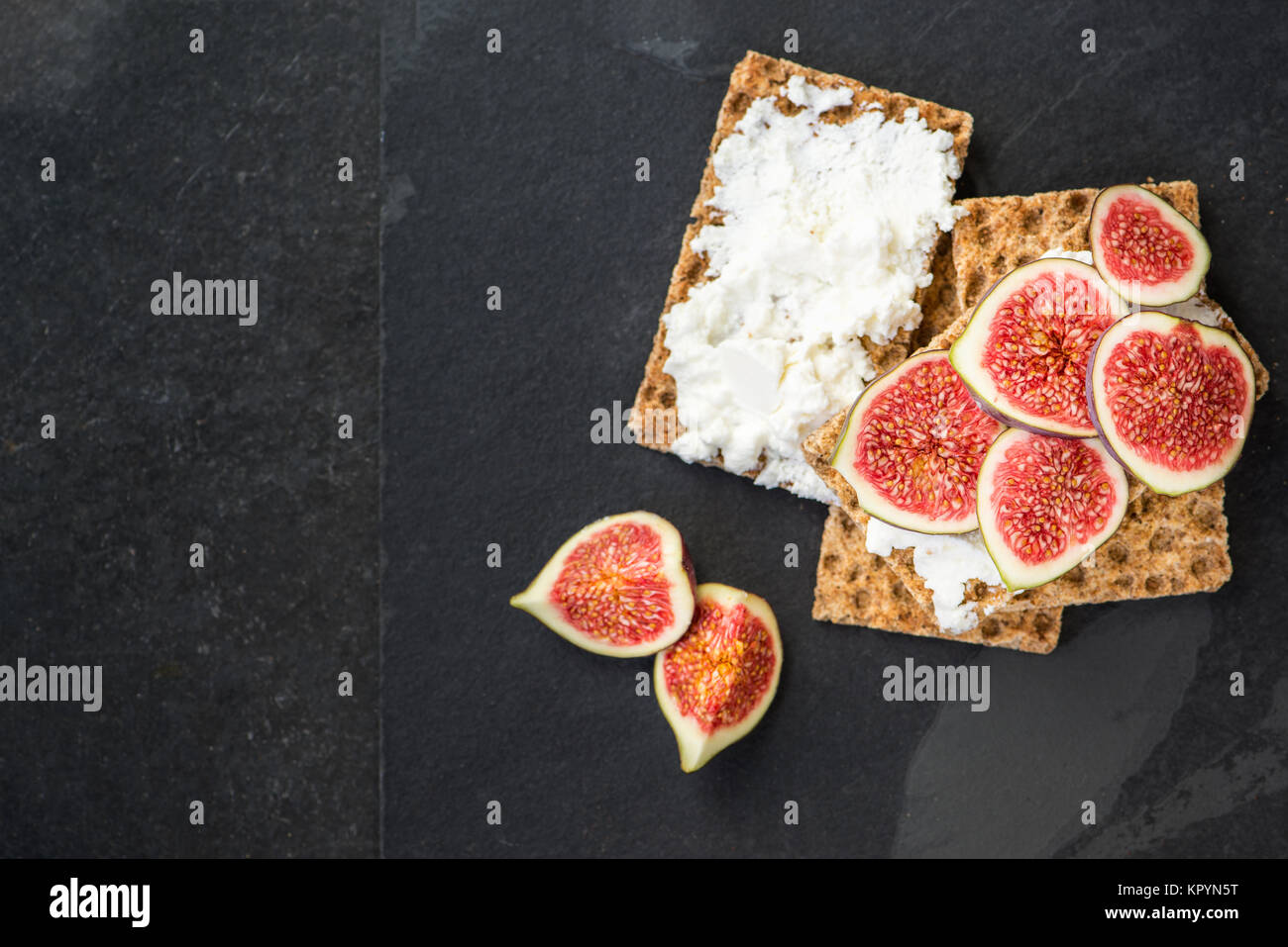 Healthy snack from wholegrain rye crispbread crackers, figs and ricotta