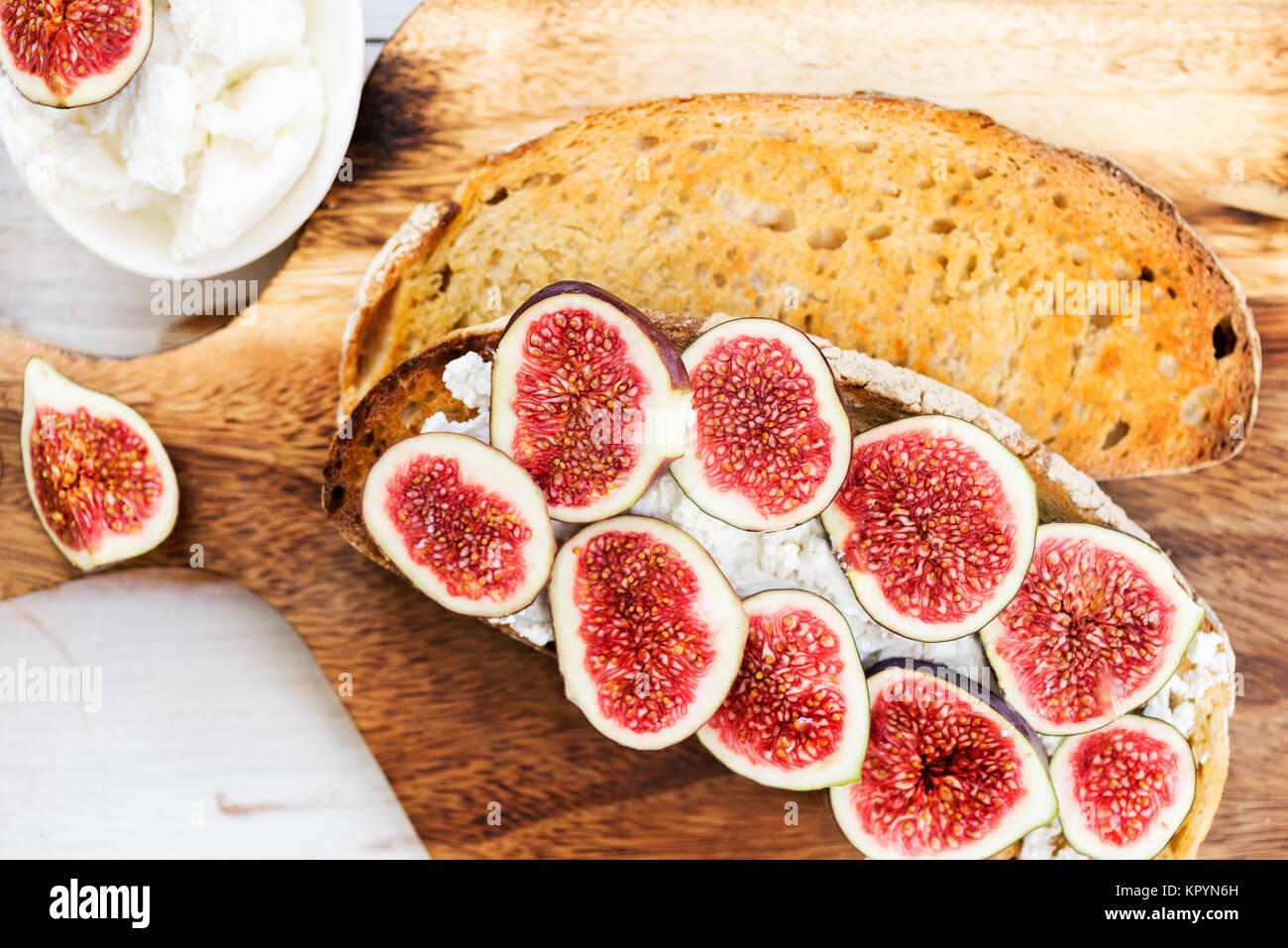 Healthy snack from sourdough bread toasts, figs and ricotta cheese on