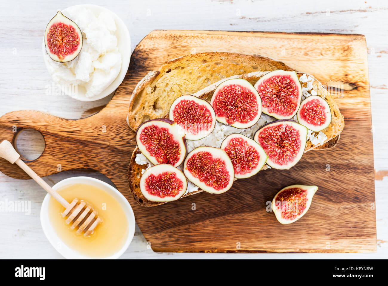 Healthy snack from sourdough bread toasts, figs and ricotta cheese on