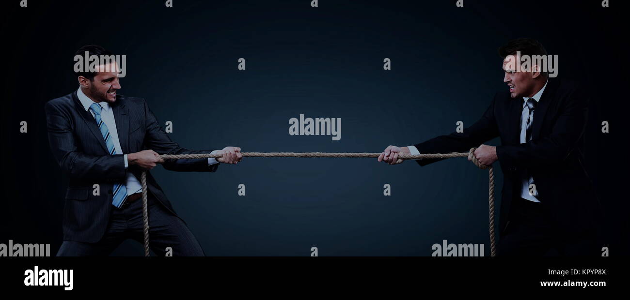 Two business men pulling rope in a competition Stock Photo Alamy
